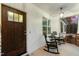 Inviting front porch featuring a rocking chair and pendant lighting at 100 Lexington Ave, Zebulon, NC 27597