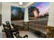 Inviting front porch featuring rocking chairs, stone pillars, and an outdoor flag at 100 Lexington Ave, Zebulon, NC 27597