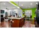 Open kitchen featuring a center island, stainless appliances, and views to Gathering room at 100 Lexington Ave, Zebulon, NC 27597