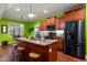 Spacious kitchen with granite countertops, stainless steel appliances, and breakfast bar at 100 Lexington Ave, Zebulon, NC 27597