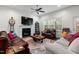 Comfortable living room featuring a fireplace, ceiling fan, hardwood floors, and plenty of seating at 100 Lexington Ave, Zebulon, NC 27597