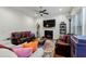 Cozy living room with a fireplace, plush sofas, a ceiling fan, and a decorative area rug at 100 Lexington Ave, Zebulon, NC 27597