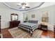 Comfortable main bedroom with hardwood floors, ceiling fan, and a decorative rug at 100 Lexington Ave, Zebulon, NC 27597
