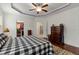Spacious main bedroom featuring a trey ceiling, walk-in closet, ensuite bathroom, and hardwood floors at 100 Lexington Ave, Zebulon, NC 27597