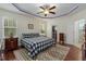 Comfortable main bedroom with a ceiling fan, a checkered comforter, and an ensuite bathroom at 100 Lexington Ave, Zebulon, NC 27597