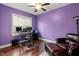 Cozy purple office space with hardwood floors, a desk, and comfortable chair at 100 Lexington Ave, Zebulon, NC 27597