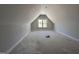 Spacious unfinished attic room with natural light coming from the window at 100 Spumante Ct, Princeton, NC 27569