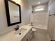 Stylish bathroom featuring a modern sink, vanity, framed mirror, and a shower-tub combo at 100 Spumante Ct, Princeton, NC 27569
