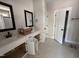 Bathroom featuring double vanities, black fixtures, and decorative tiled floors at 100 Spumante Ct, Princeton, NC 27569