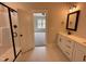 Modern bathroom with decorative tile floor, a glass-enclosed shower and a double vanity at 100 Spumante Ct, Princeton, NC 27569