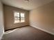 Neutral bedroom featuring a carpeted floor, a window bringing in natural light, and fresh paint at 100 Spumante Ct, Princeton, NC 27569