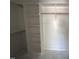 Walk-in closet with shelving and rods for organizing clothes at 100 Spumante Ct, Princeton, NC 27569