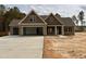 Inviting two-story home with a three-car garage and stone accents in a well-developed community at 100 Spumante Ct, Princeton, NC 27569