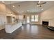 Gourmet kitchen with granite countertops, stainless steel appliances, a center island, and an adjoining fireplace at 100 Spumante Ct, Princeton, NC 27569