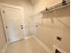 Functional laundry room with decorative tile flooring and storage at 100 Spumante Ct, Princeton, NC 27569