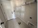 Neutral laundry room features patterned tile floor, white shelving, and a white painted door at 100 Spumante Ct, Princeton, NC 27569