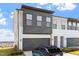 Modern two-story townhome showcasing a dark garage door and a mix of white brick and gray siding at 1004 Westerland Way # 197, Durham, NC 27703