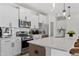 Contemporary kitchen boasts white cabinetry, stainless steel appliances, and a spacious countertop at 1004 Westerland Way # 197, Durham, NC 27703
