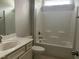 Well-lit bathroom features a vanity with sink and a bathtub-shower combination at 1006 Pondfield Way, Durham, NC 27713