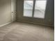 Bedroom featuring plush carpet, a window, and natural light at 1006 Pondfield Way, Durham, NC 27713