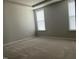 Bright bedroom with plush carpeting and natural light from two large windows at 1006 Pondfield Way, Durham, NC 27713