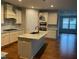 Bright kitchen features an island with granite countertops, stainless steel appliances, and ample cabinet space at 1006 Pondfield Way, Durham, NC 27713