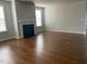 Living room showcasing a modern fireplace and hardwood flooring at 1006 Pondfield Way, Durham, NC 27713