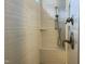 Custom tiled shower featuring built-in bench and modern fixture at 1006 Pondfield Way, Durham, NC 27713