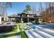 Expansive backyard featuring a modern pool, well-manicured lawn, and luxurious outdoor seating at 1012 Casa Dega Way, Raleigh, NC 27613