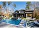 Stunning backyard featuring a sparkling pool, spa, and meticulously designed landscaping at 1012 Casa Dega Way, Raleigh, NC 27613