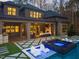 Backyard view showcasing a pool, spa, and covered patio with a fireplace, creating an ideal outdoor retreat at 1012 Casa Dega Way, Raleigh, NC 27613