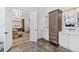 A well-lit bathroom features white cabinets, dark tile floors, an open door, and a stylish bathtub at 1012 Casa Dega Way, Raleigh, NC 27613