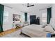 Bright bedroom featuring hardwood floors, a white bed, natural light, and classic decor at 1012 Casa Dega Way, Raleigh, NC 27613
