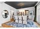 Elegant dining room with a wood table, upholstered chairs, dark ceiling, and sophisticated decor at 1012 Casa Dega Way, Raleigh, NC 27613