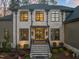 Elegant two-story home featuring a stone facade, black framed windows, and a grand entrance at 1012 Casa Dega Way, Raleigh, NC 27613