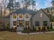Stunning two-story home with a stone facade, manicured landscaping, and a welcoming entrance at 1012 Casa Dega Way, Raleigh, NC 27613