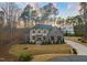 Striking home with a stone and siding facade, professionally landscaped yard, and a curved driveway at 1012 Casa Dega Way, Raleigh, NC 27613