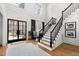 Bright foyer with hardwood floors, staircase, high ceilings, and natural light from large windows at 1012 Casa Dega Way, Raleigh, NC 27613