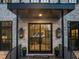Grand front entrance with stone accents, decorative lighting, and a welcoming doorway at 1012 Casa Dega Way, Raleigh, NC 27613