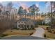 Beautiful home exterior showcasing a well-manicured lawn, elegant landscaping, and a curved driveway at 1012 Casa Dega Way, Raleigh, NC 27613