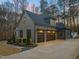 Attached three-car garage with black doors and accent lighting at 1012 Casa Dega Way, Raleigh, NC 27613