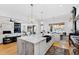 Bright, open kitchen with large island, modern fixtures, and a view of the living area at 1012 Casa Dega Way, Raleigh, NC 27613