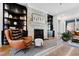 Cozy living room features a stone fireplace, hardwood floors, and custom built-in shelving at 1012 Casa Dega Way, Raleigh, NC 27613
