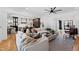 Spacious living room with hardwood floors and large windows, offering ample natural light and views to kitchen at 1012 Casa Dega Way, Raleigh, NC 27613