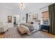 A beautifully decorated bedroom features a large rug, a decorative chandelier, and a luxurious bed with lots of pillows at 1012 Casa Dega Way, Raleigh, NC 27613