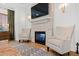 A spacious bedroom with a stone fireplace, flatscreen TV, hardwood floors, and natural light at 1012 Casa Dega Way, Raleigh, NC 27613