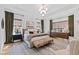 Spacious main bedroom with neutral tones, tray ceiling, and sitting area at 1012 Casa Dega Way, Raleigh, NC 27613