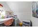 Bright office space featuring a white built-in desk, cozy pink chair and ample storage for organization at 1012 Casa Dega Way, Raleigh, NC 27613