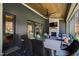 Covered outdoor patio featuring dining and lounge areas with a fireplace and ceiling fan at 1012 Casa Dega Way, Raleigh, NC 27613