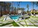 Luxurious pool with a spa and stepping stones surrounded by lush landscaping at 1012 Casa Dega Way, Raleigh, NC 27613